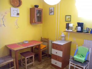 a room with a table and some chairs and a table and a table and chairs at Apartment in Balatonalmadi/Balaton 17977 in Balatonalmádi