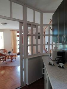 a kitchen with glass doors and a counter top at Apartment in Zalakaros/Thermalbad 33089 in Zalakaros