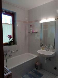a bathroom with a sink and a bath tub and a sink at Apartment in Zalakaros/Thermalbad 33089 in Zalakaros