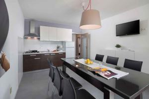 a kitchen and dining room with a table and chairs at Apartment Rabac 11 in Rabac +14 photos