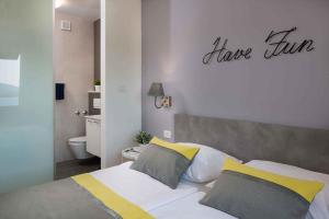 a bedroom with a bed with a have time sign on the wall at Apartment Rabac 11 in Rabac