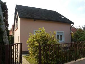 a small house with a fence in front of it at Holiday home in Balatonfenyves 18412 in Balatonfenyves