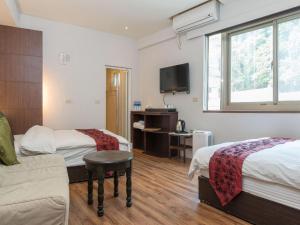 Postel nebo postele na pokoji v ubytování Chiu Chunt Dint B&B