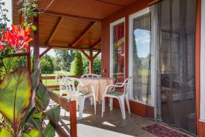 a porch with a table and chairs on it at Holiday home in Balatonmariafürdo 19260 in Balatonmáriafürdő