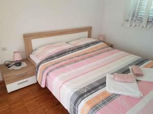 a small bedroom with a bed and a night stand at Apartment in Silo/Insel Krk 13496 in Šilo