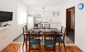 a kitchen with a dining room table and chairs at Apartment in Medulin/Istrien 9070 in Medulin
