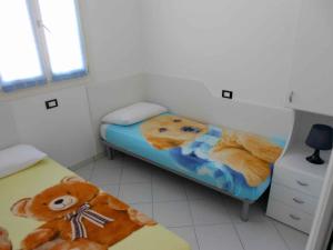 a small bedroom with a teddy bear laying on a bed at Holiday Homes in Rosolina Mare 25014 in Rosolina Mare