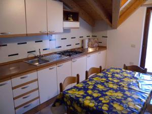 a kitchen with a table with a table cloth on it at Apartment Pieve di Ledro 3 in Ledro