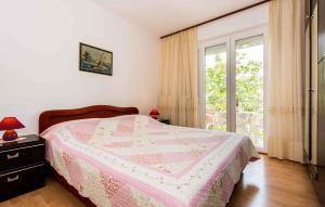 a bedroom with a pink bed and a window at Apartment in Silo/Insel Krk 13499 in Šilo