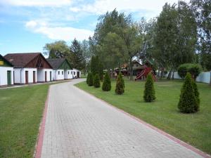 a brick path in a park with trees and a playground at Apartment in Balatonbereny/Balaton 18075 in Balatonberény