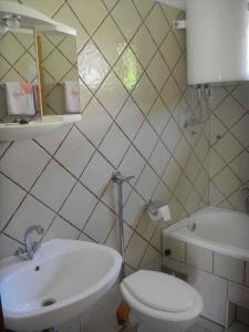 a white bathroom with a sink and a toilet at One-Bedroom Apartment Novi Vinodolski near Sea 7 in Povile