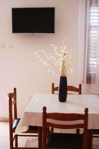 a vase of flowers on a table in a living room at One-Bedroom Apartment Novi Vinodolski near Sea 7 in Povile