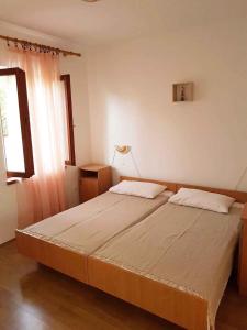 a large bed in a room with a window at One-Bedroom Apartment Novi Vinodolski near Sea 7 in Povile