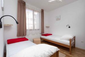 a room with two beds and a window at Apartment in Silo/Insel Krk 13438 in Šilo