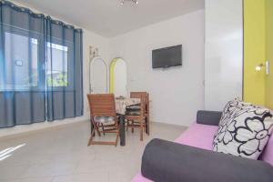 a living room with a couch and a table at Apartment in Krk/Insel Krk 12637 in Krk