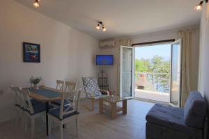 a living room with a table and chairs and a window at Apartment in Silo/Insel Krk 13416 in Šilo