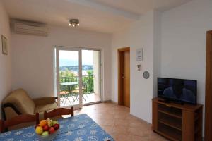 a living room with a television and a table with fruit on it at Apartment in Silo/Insel Krk 13433 in Šilo