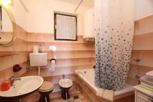 a bathroom with a sink and a shower curtain at Apartment Silo 46 in Šilo
