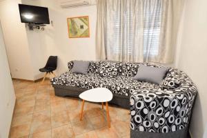 a living room with a black and white couch and a table at Apartment Pula, Brijuni, Istria 2 in Veruda