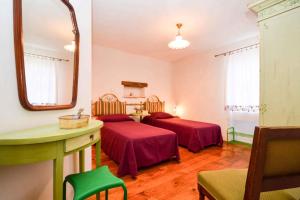 a hotel room with two beds and a mirror at Holiday home in Liznjan/Istrien 8962 in Ližnjan