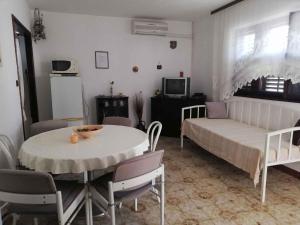 a living room with a bed and a table and chairs at Apartment in Petrcane/Zadar Riviera 7866 in Petrcane