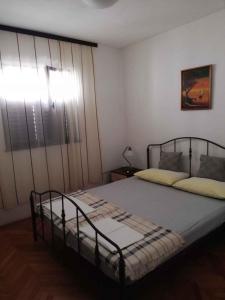 a bedroom with two beds and a window at Apartment in Petrcane/Zadar Riviera 7866 in Petrcane
