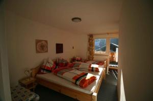 a bedroom with two beds and a window at Holiday home Strobl/Salzburger Land 103 in Weissenbach