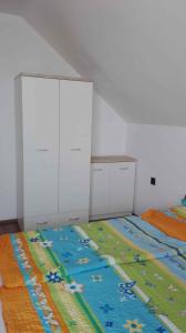 a bedroom with two beds with a colorful blanket at Apartment Balatonlelle 6 in Balatonlelle