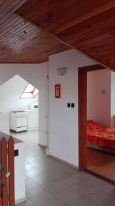 a room with a bed and a wooden ceiling at Apartment Balatonlelle 6 in Balatonlelle