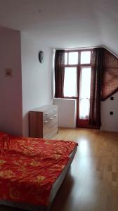 a bedroom with a bed and a large window at Apartment Balatonlelle 6 in Balatonlelle