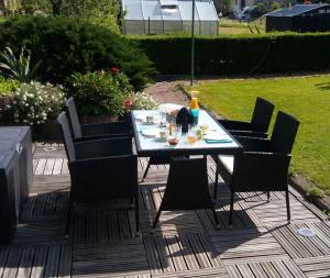 a table with chairs and a table with food on it at Apartment in Wutha-Farnroda 3178 in Mosbach