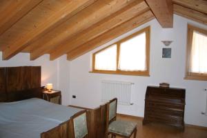 レードロにあるHoliday home in Pieve di Ledro 22670のベッドルーム1室(ベッド1台、ドレッサー、窓2つ付)