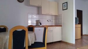 a kitchen with a table and chairs in a room at Studio in Starigrad-Paklenica 6776 in Starigrad-Paklenica