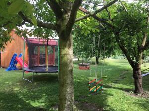 a playground in a yard with a tree at Apartment Siofok, Lake Balaton 1 in Siófok