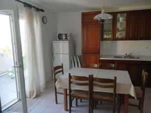 een keuken met een tafel en stoelen en een keuken met een wastafel bij Apartment in Ugljan - Insel Ugljan 7453 in Ugljan