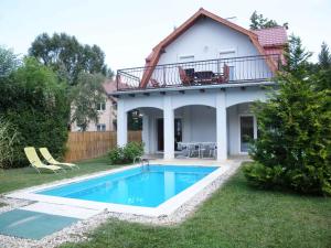 a house with a swimming pool in the yard at Holiday home in Siofok - Balaton 20063 in Siófok