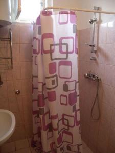 a shower curtain in a bathroom with a sink at Apartment Balatonfenyves - Balaton 18390 in Balatonfenyves +26 photos