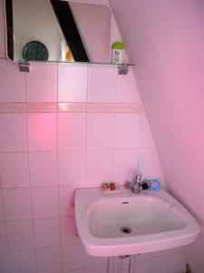 a bathroom with a sink and a pink wall at Holiday home Balatonlelle/Balaton 19077 in Balatonlelle