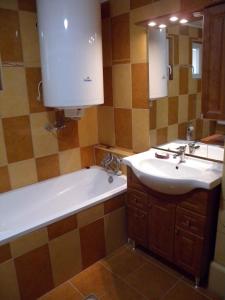 a bathroom with a sink and a bath tub and a sink at Holiday home in Balatonfenyves 18379 in Balatonfenyves