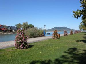 a row of bushes with flowers in a park at Holiday home in Fonyod/Balaton 18566 in Fonyód