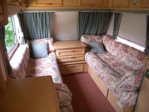 a small room with two couches in a caravan at Holiday home Balatonkenese - Balaton 18975 in Balatonkenese