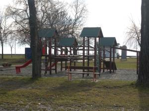 a park with a playground with benches and trees at Holiday home Balatonkenese - Balaton 18975 in Balatonkenese
