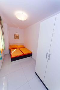 a small bedroom with a bed and a shower at Apartment Crikvenica, Vinodol 3 in Crikvenica