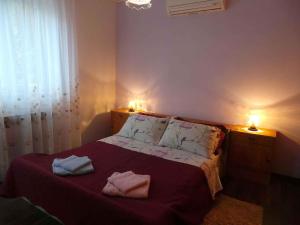 Postel nebo postele na pokoji v ubytování Apartment Lovran 15546