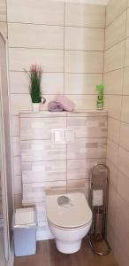 a bathroom with a toilet and a plant on a wall at Apartment in Medulin/Istrien 9043 in Medulin