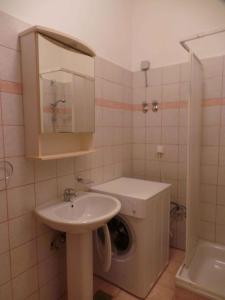 a bathroom with a sink and a washing machine at Apartment in Labin/Istrien 8760 in Labin