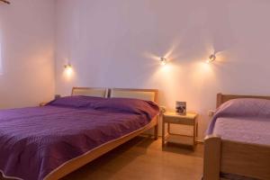 a bedroom with two beds and two lights on the wall at Apartment in Pula/Istrien 11168 in Veli Vrh