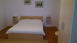 a bedroom with a white bed in a room at Apartment Medulin 12 in Medulin