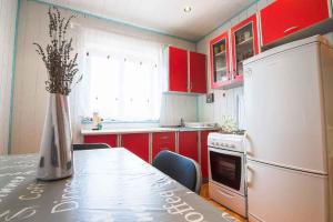 a kitchen with red cabinets and a table and a refrigerator at Apartment in Banjole/Istrien 11157 in Banjole