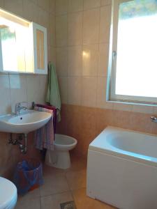 a bathroom with a sink and a tub and a toilet at Holiday home in Banjole/Istrien 10808 in Banjole